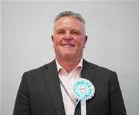 The profile card picture of Cllr Tom Garnett